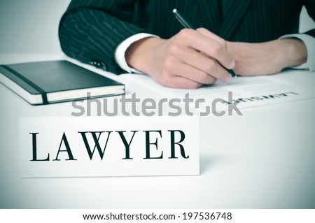 a man in his desk with a nameplate in front of him with the word lawyer written in it