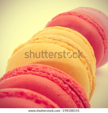 some appetizing macarons of different flavors with a retro filter effect