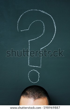 a man over a blackboard with a question mark drawn in it