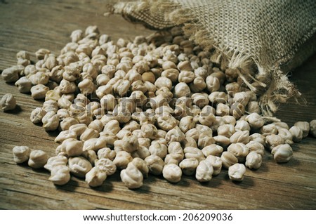 a pile of dried chickpeas on a rustic wooden table
