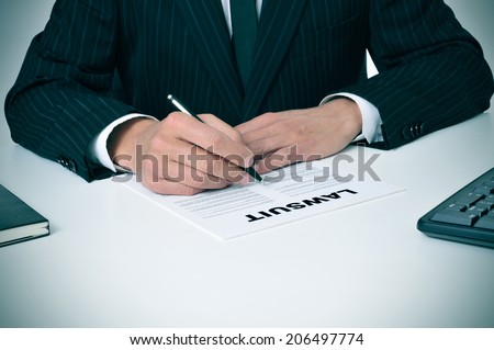 a lawyer in his office with a document with the text lawsuit written in it