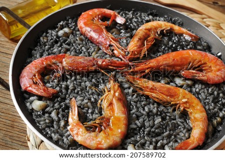 closeup of spanish arroz negro, a typical rice casserole made with squid ink