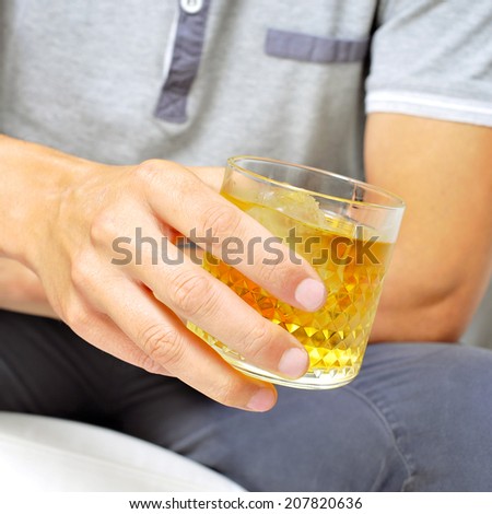 young man hanging out with a glass of liquor