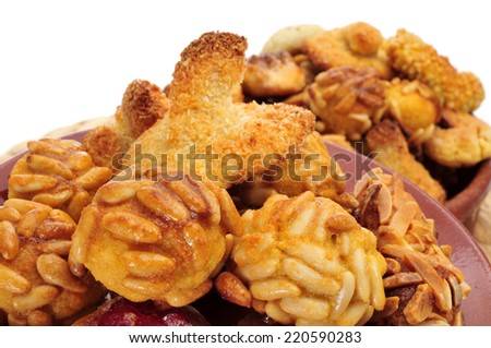 closeup of a pile of panellets, typical pastries of Catalonia, Spain, eaten in All Saints Day, on a white background