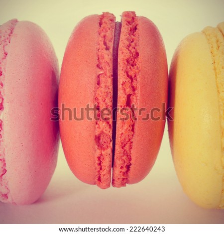 closeup of some appetizing macarons with different colors and flavors, with a retro effect