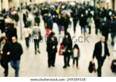 defocused blur background of people walking in a pedestrian street