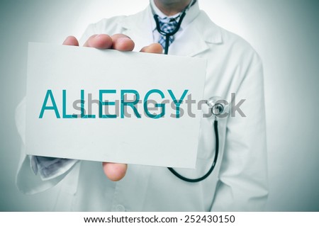 a doctor showing a signboard with the word allergy written in it