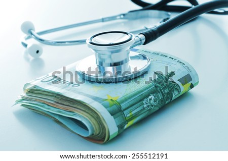 a stethoscope on a wad of euro bills, depicting the concept of the health care industry or the health care costs