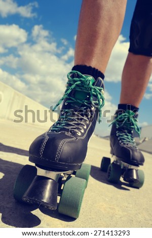 closeup of the feet of a young caucasian man roller skating with quad skates