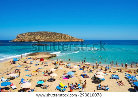 SAN ANTONIO, SPAIN - JUNE 15: Sunbathers at Cala Conta beach on June 15, 2015, in San Antonio, in Ibiza Island, Spain. Ibiza is a well-known summer tourist destination in Europe