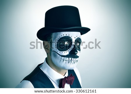portrait of a young man with mexican calaveras makeup, wearing bow tie and top hat, with a slight vignette added