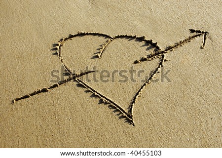 heart  with arrow drawing  in the sand