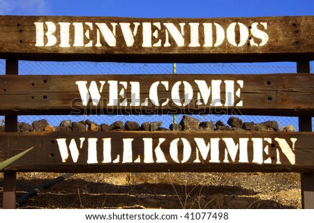 sign with the word welcome in different languages