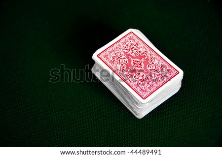 a deck of cards over the green playing mat
