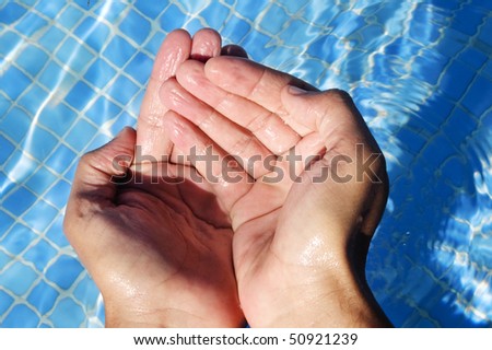 water falling from the hands on a swimming pool
