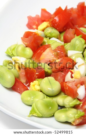 close up of a broad beans salad with tomato and boiled egg