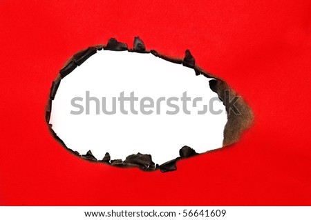 burned hole on a red paper on a white background