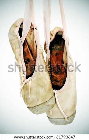 a pair of old pointe shoes isolated on a white background