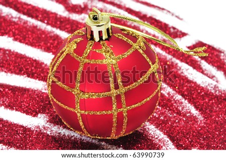 red and golden christmas ball with red glitter on a white background