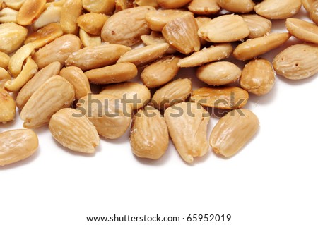 a pile of salted almonds isolated on a white background