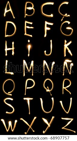 light yellow background. stock photo : light yellow letters on a black ackground