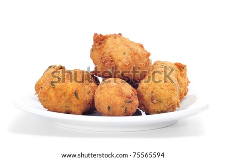 a plate with some cod fritters on a white background
