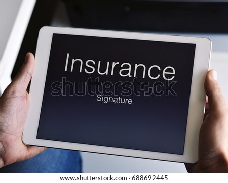 closeup of a young caucasian man about to sign an insurance policy in a digital tablet