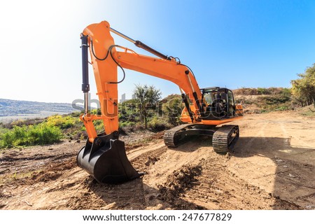 Heavy earth mover on a sunny day with the blue sky in the background