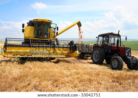 tractor and combine harvested wheat