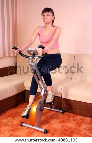 Stationary bicycle on train woman