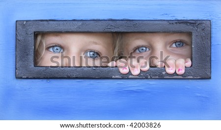 sisters hiding behind a door peeping thru a letter box