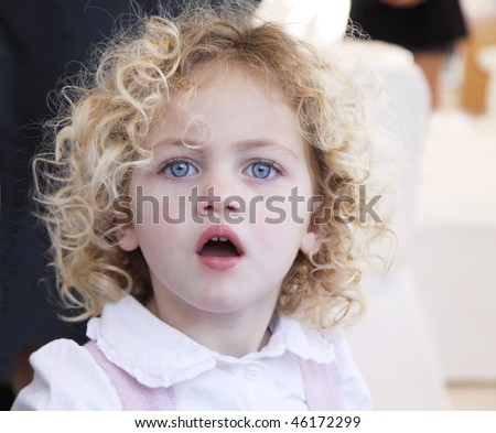 stock photo : portrait of a pretty toddler with blue eyes and blonde curly 