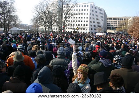 WASHINGTON, DC - JANUARY 20, 2009: Woman holds her ticket up in a crowd waiting at a security gate to enter the standing area near the Capitol on January 20, 2009. Many were turned away.