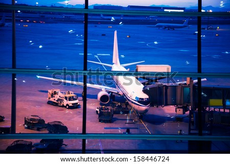 Parked aircraft on beijing airport through the gate window