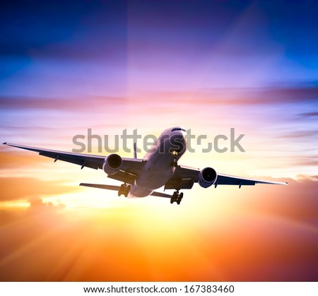 Airplane in the sky at sunrise