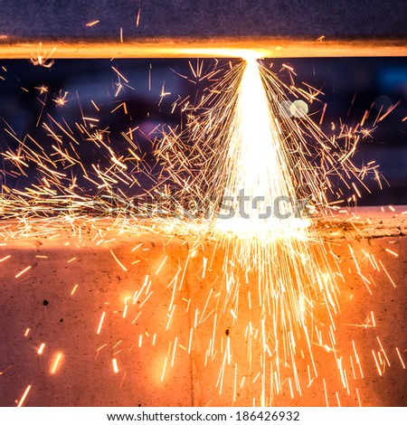 worker cutting steel pipe using metal torch and install roadside fence