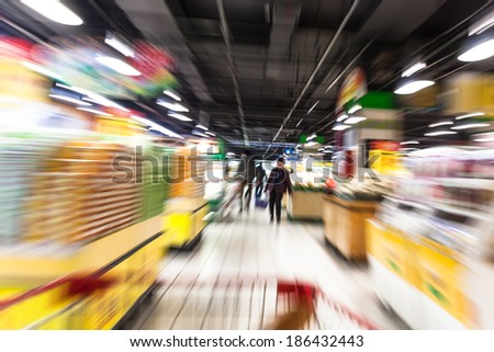 Young woman shopping in the supermarket,motion blur