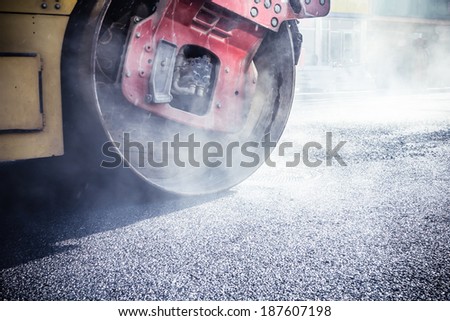 Road roller repairing asphalt pavement