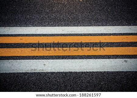 Road texture with white and yellow stripes