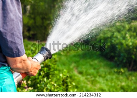 men hand watering the plants