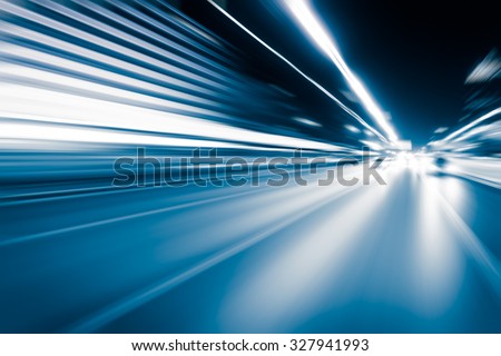 Abstract speed motion in highway road tunnel, blurred motion toward the central