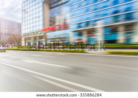 Car driving on road in city background, motion blur