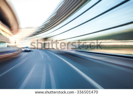 Car driving on road in city background, motion blur