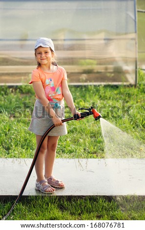 girl hose grass