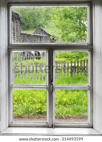 Wooden window frame during a rain in the summer