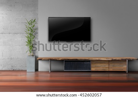 Living room led tv on gray wall with wooden table and plant in pot modern loft style