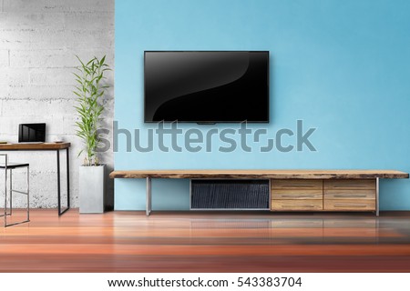 Tv on light blue wall with wooden table and plant in pot empty living room interrior