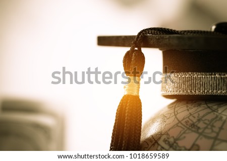 Graduate study abroad concept, Graduation cap on top Earth globe model map on laptop with Radar background. Graduate study abroad program, Back to School and Studies lead to success