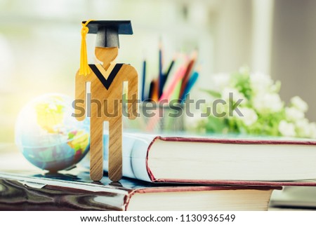 Education knowledge learning study abroad international Ideas. People Sign wood with Graduation celebrating cap on open textbook, America global map show alternative studying Back to School Concept