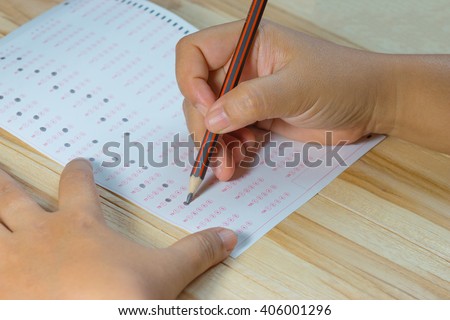 student testing in exercise, exams answer sheets on table